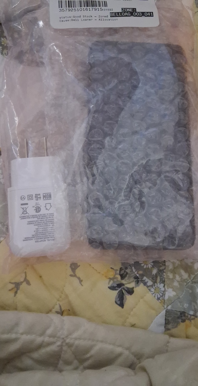 LG Black Smartphone with White Wall Charger